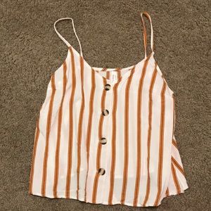 Striped rusted and white colored tank with buttons that work. Spaghetti straps.